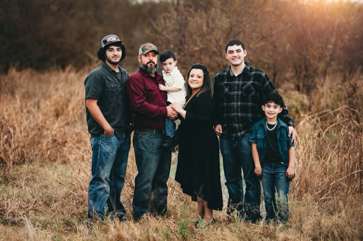 The Thornton family standing together in a golden field